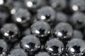 Metal balls arranged side by side to form an organized structure. Macro scale photo with shallow depth of field. Glossy surface Royalty Free Stock Photo