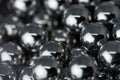 Metal balls arranged side by side to form an organized structure. Macro scale photo with shallow depth of field. Glossy surface Royalty Free Stock Photo