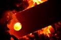 A metal bar with a hole is heated on coal.