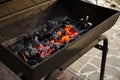 Metal barbecue grill with burning charcoal inside ready for grilling Royalty Free Stock Photo
