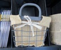 Metal basket with burlap liner on shelf.