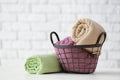 Metal basket with clean soft towels on white table Royalty Free Stock Photo