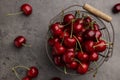 Metal basket with ripe sweet cherries on grey table, flat lay Royalty Free Stock Photo