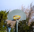 Metal basketball hoop and orange rim in park. Royalty Free Stock Photo