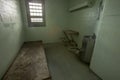 Metal bed inside solitary confinement cell