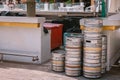 Metal beer barrels stand behind the summer open bar, close up photo Royalty Free Stock Photo