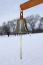 Metal Bell with Winter Snowy Fields in Background