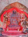 Metal bells offered by devotees at Kali Temple. Shrine full of red pigment to worship Goddess Kali at Dhulikhel in Nepal