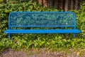 Metal bench in blue with leaves