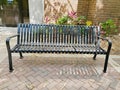 Metal bench by brick wall