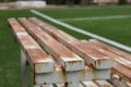 A metal bench with rusty white paint