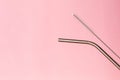 Metal, bendy drinking straw and steel cleaning brush on pink background. Aluminum stainless reusable bar equipment for drink Royalty Free Stock Photo
