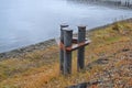 Metal berth for ships at sea. Rusty Mooring Bollard. Mooring in the port, with the sea in the background Royalty Free Stock Photo