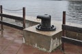 Metal berth for ships at sea. Rusty Mooring Bollard. Mooring in the port, with the sea in the background Royalty Free Stock Photo