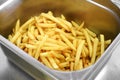 Metal bin filled with golden crispy potato chips