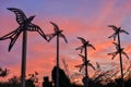 Metal birds flying into the sunset skies. Shoreline Park, Mountain View, California