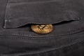 metal bitcoin coin in pants pocket, cryptocurrency, cost management concept