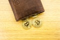 Metal bitcoins in brown leather wallet. Bitcoin - modern virtual. 3D illustration