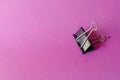 Metal black Binder Clips on a pink background Royalty Free Stock Photo