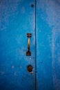 Metal blue door with a brown handle and lock in closeup Royalty Free Stock Photo