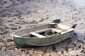 A metal boat with oars on the river bank. Fishing season Royalty Free Stock Photo