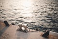 Metal bollard for boats and vessels on wharf over sea and sunset background close up.