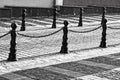 Metal bollards and chain between them on revolutionary street in Minsk