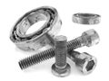 Metal bolts and bearings on white