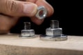 Metal bolts and nuts for joining wood. Tightening the screws with an adjustable wrench