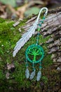 Metal bookmark with dreamcatcher handmade on the bark tree