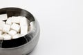 Metal bowl with cubes of white refined sugar for tea and coffee Royalty Free Stock Photo