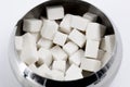 Metal bowl with cubes of white refined sugar for tea and coffee top view Royalty Free Stock Photo