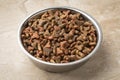Metal bowl with dry cat food close up