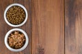 Metal bowls with various pet food. Royalty Free Stock Photo