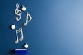 Metal box with scattering christmas balls and music notes on blue background Royalty Free Stock Photo