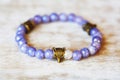 metal brass pendant beed on violet angelite mineral stone bracelet Royalty Free Stock Photo