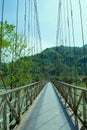 Metal bridge over a mountain river. Beautiful mountain landscape. Royalty Free Stock Photo