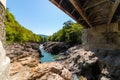 Metal bridge over a river in the mountains view from under the bridge Royalty Free Stock Photo