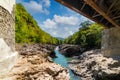 Metal bridge over a river in the mountains view from under the bridge Royalty Free Stock Photo