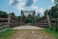 Metal Bridge Over River Under Blue Cloudy Skies Royalty Free Stock Photo