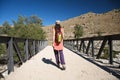 Metal bridge and trekking woman