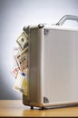 Metal briefcase full of cash on table Royalty Free Stock Photo