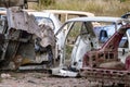Metal broken car body parts forgotten in junkyard Royalty Free Stock Photo