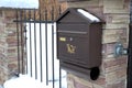 Metal brown mailbox covered with snow during winter