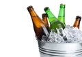 Metal bucket with bottles of beer and ice cubes on white Royalty Free Stock Photo