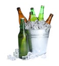 Metal bucket with bottles of beer and ice cubes isolated