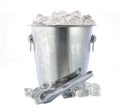 Metal bucket with crushed ice and  ice tongs isolated on white background Royalty Free Stock Photo