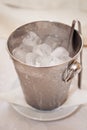 Metal bucket in drops with ice cubes Royalty Free Stock Photo