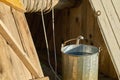 Metal bucket full of fresh water just taken up from a old wooden draw-well at countryside in a summer day Royalty Free Stock Photo