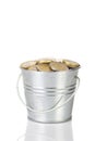 Metal bucket with handle full of coins on white background isolated alone